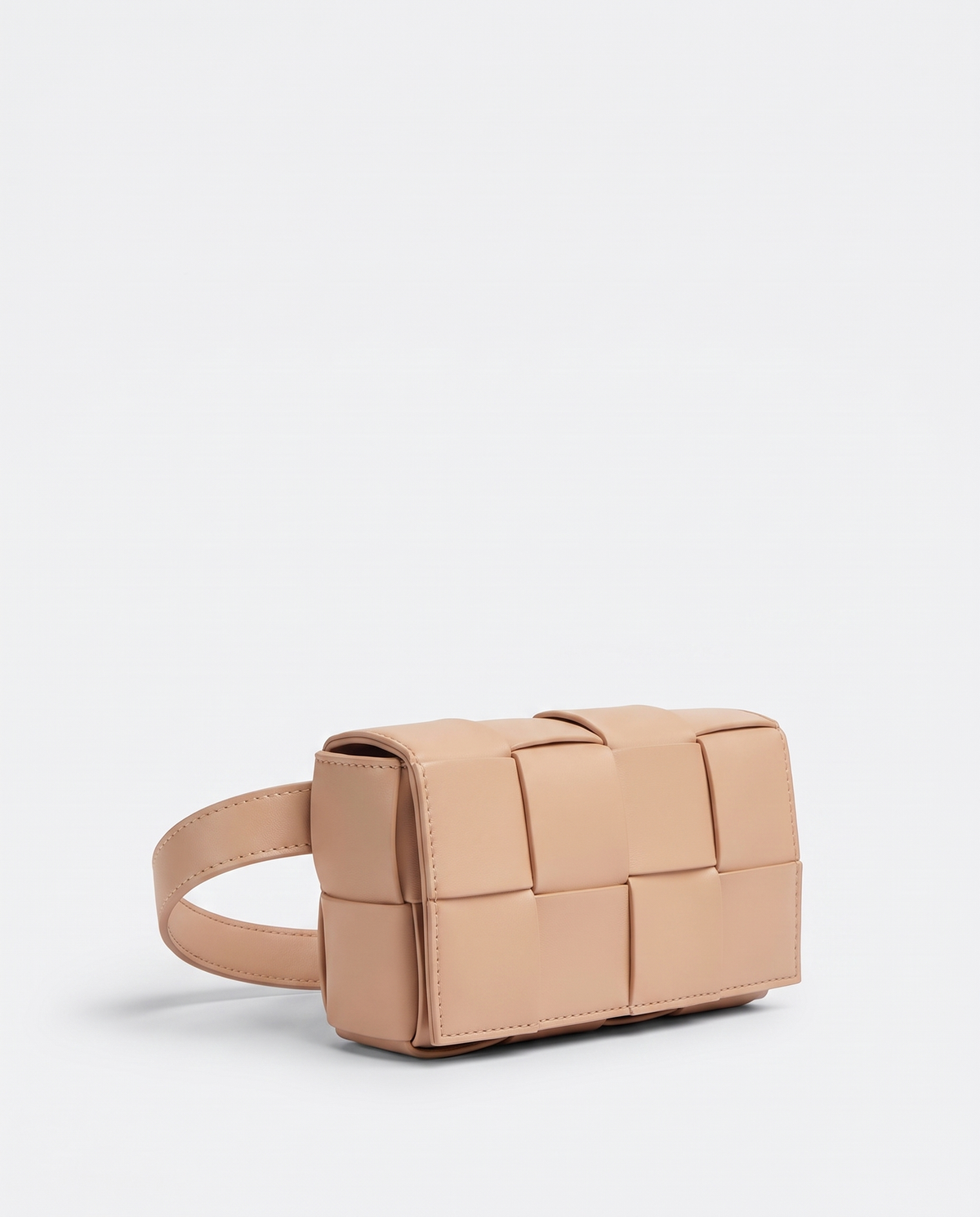 Cassette padded woven leather belt bag in Nude – three-quarter view