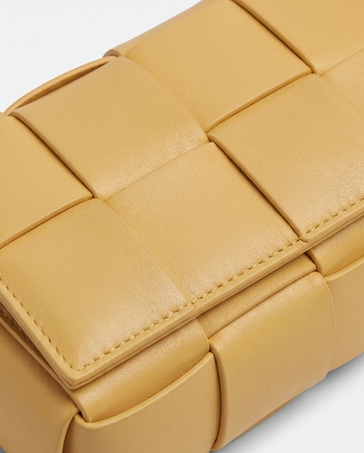 Cassette padded woven leather belt bag in Yellow – close-up of the padded woven leather