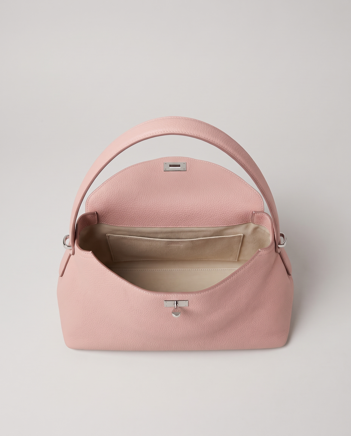 Porto pebbled leather top-handle bag in blush, open showing interior