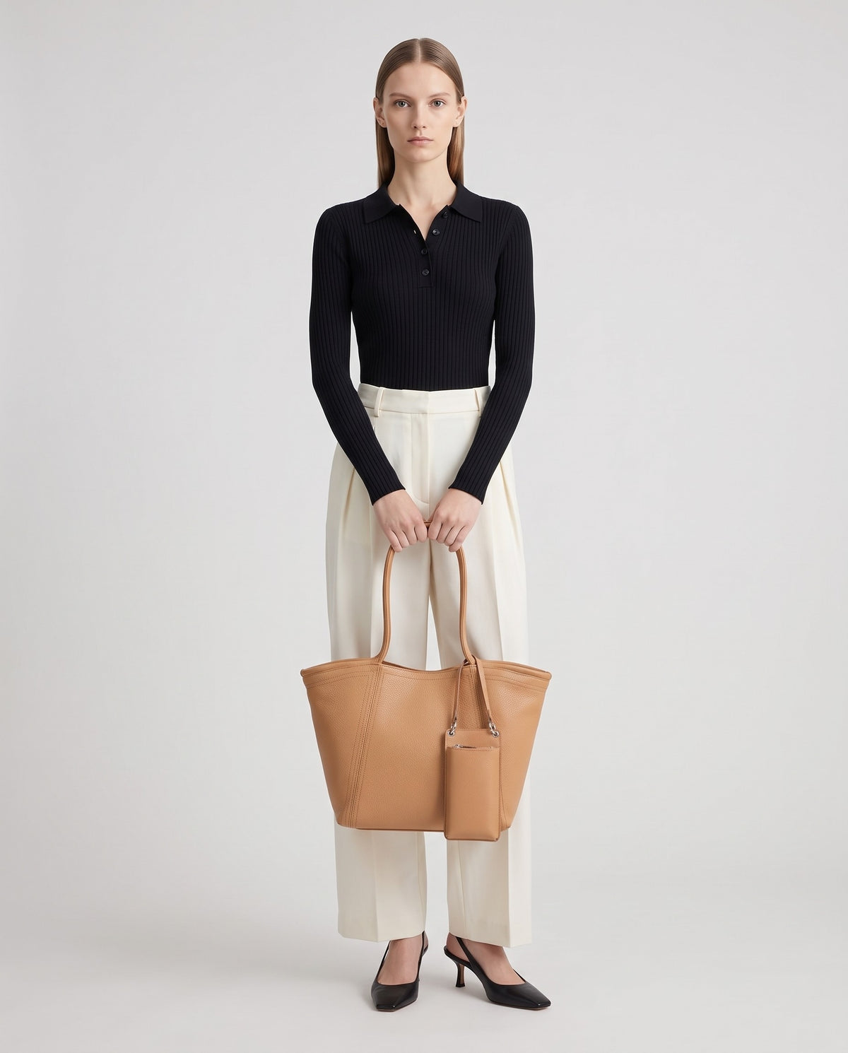 Prima leather tote in Tan – model holding it, full length