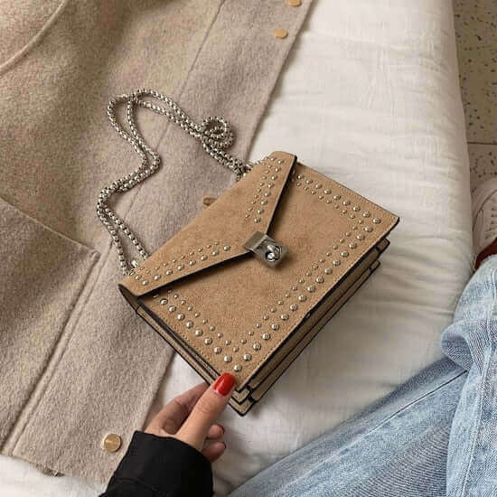 A beige studded vegan leather bag