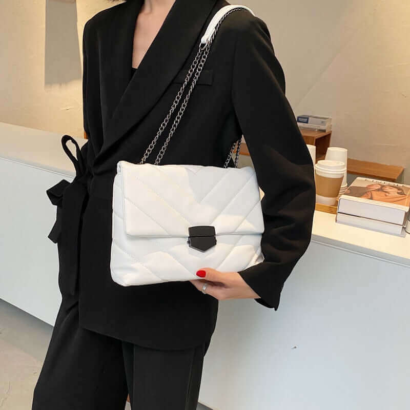 Woman carrying a V Embossed Flip Crossbody White