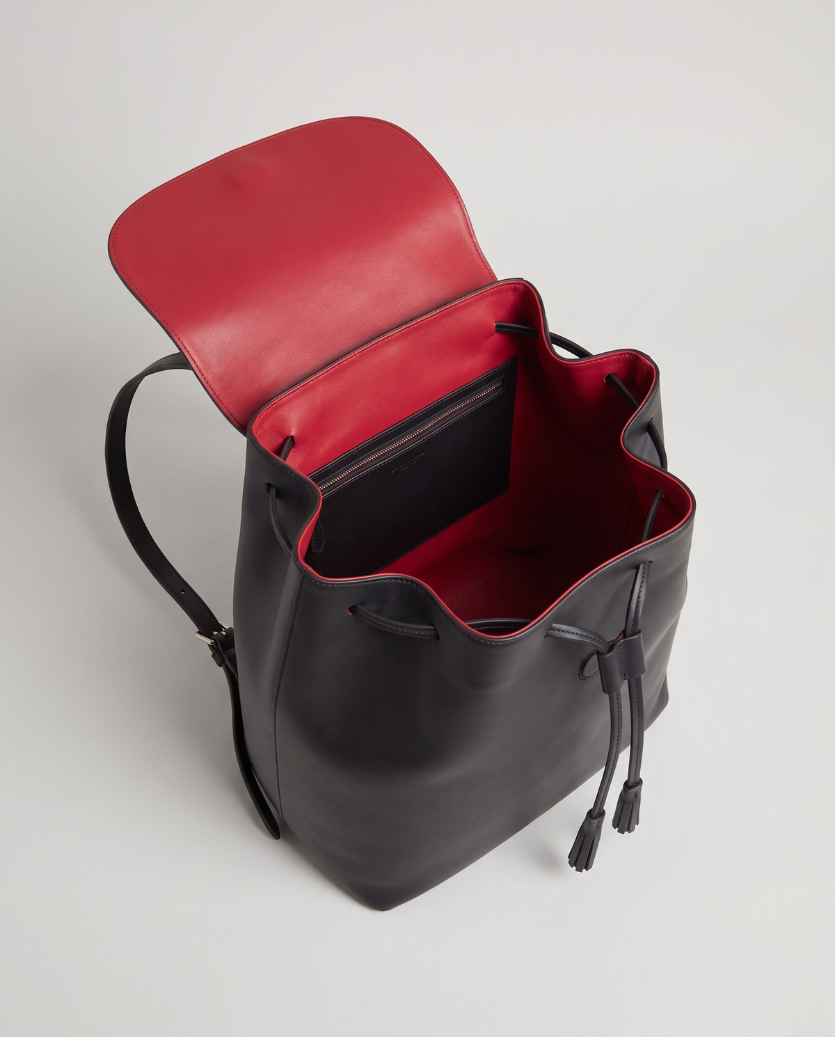 Roam Large leather backpack in Black – flap open, showing the red leather lining