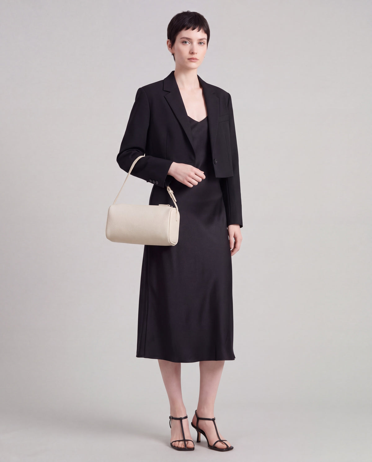 Roll bag in Ivory – carried by model, close-up