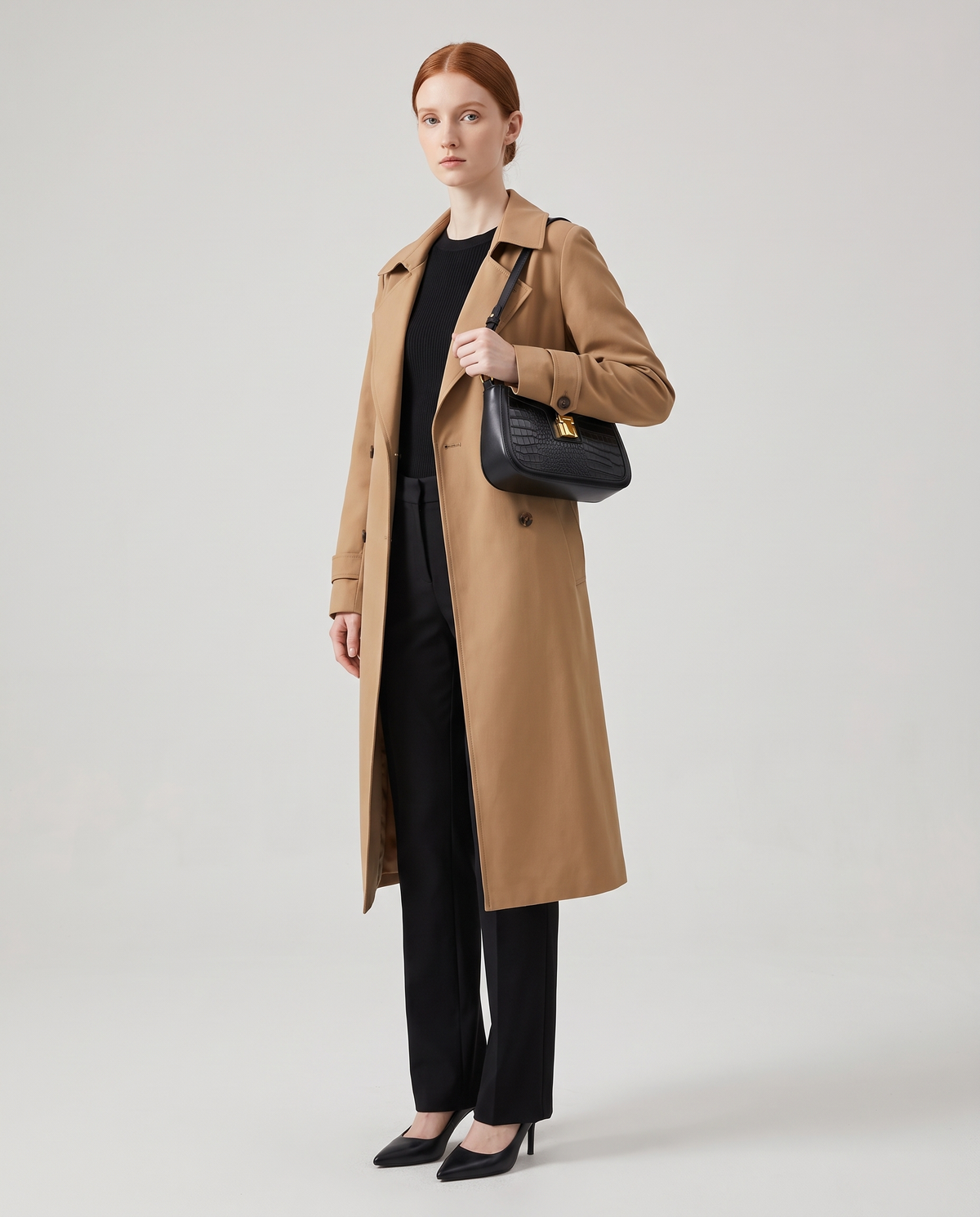 Sable croc-embossed shoulder bag in Black – model wearing it on her shoulder, full length