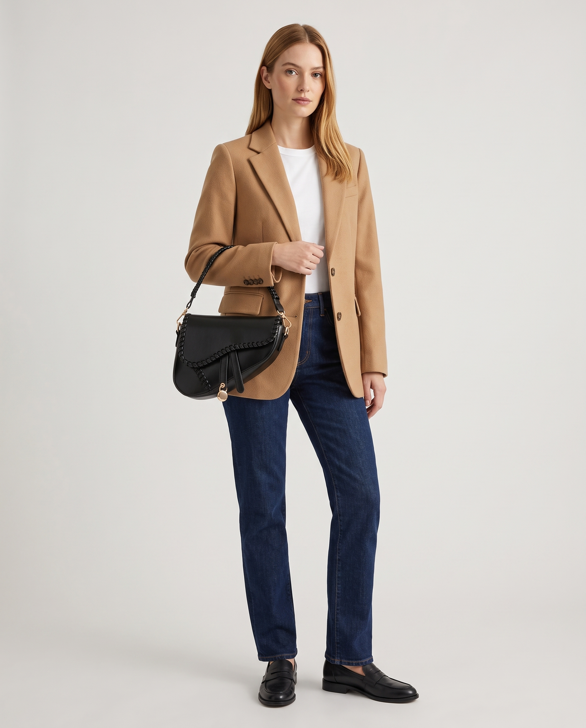 Saddle vegan leather shoulder bag in Black – model wearing it on the shoulder, full length
