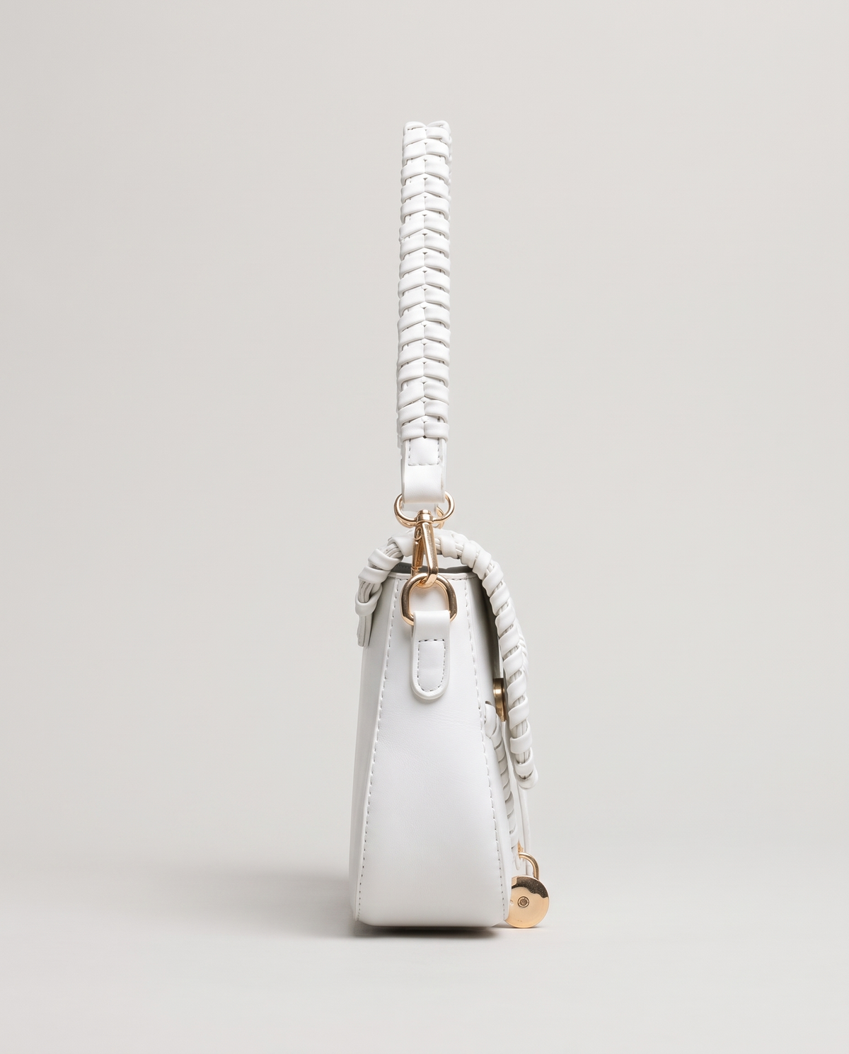 Saddle vegan leather shoulder bag in White – side view showing the braided strap