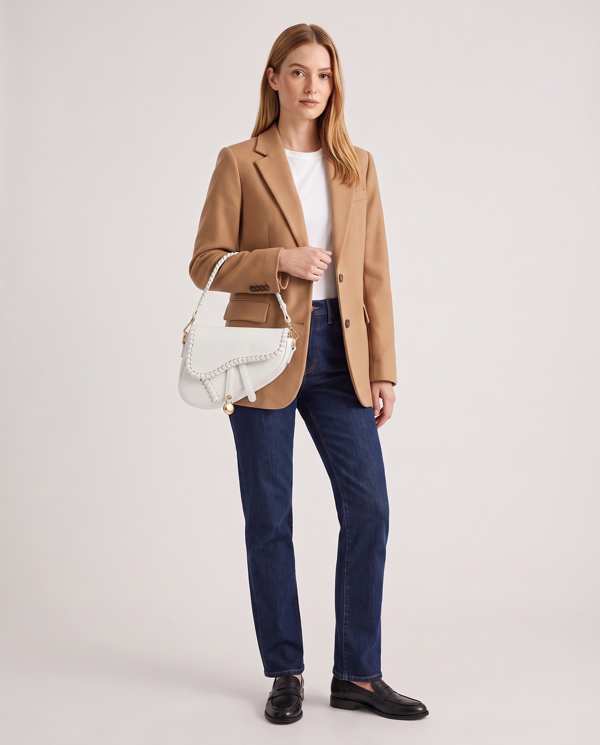 Saddle vegan leather shoulder bag in White – model wearing it on the shoulder, full length