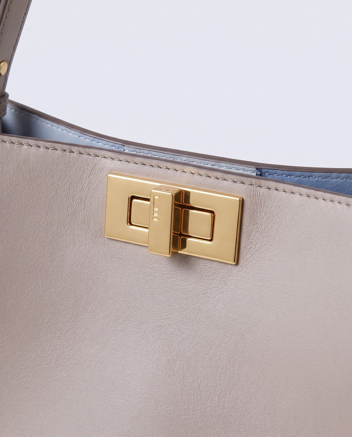 Siracusa leather bag in Stone – gold turn-lock clasp detail