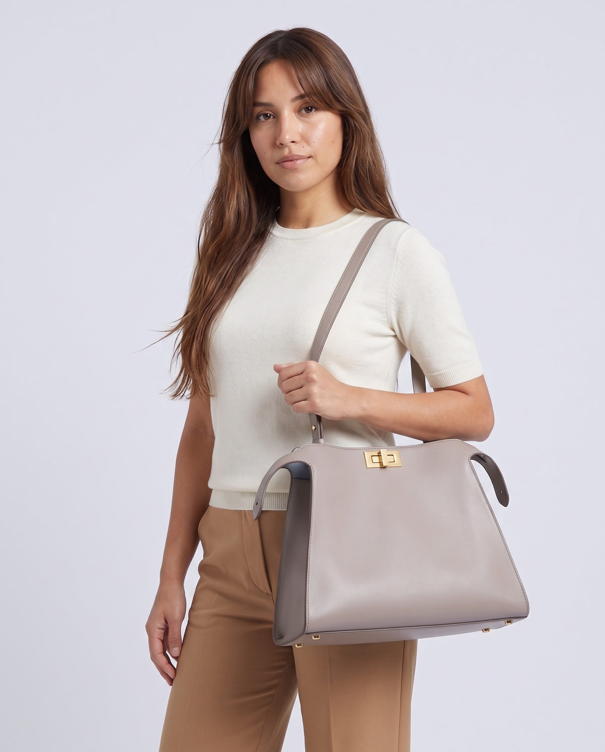 Model wearing the Siracusa leather bag in Stone on the shoulder