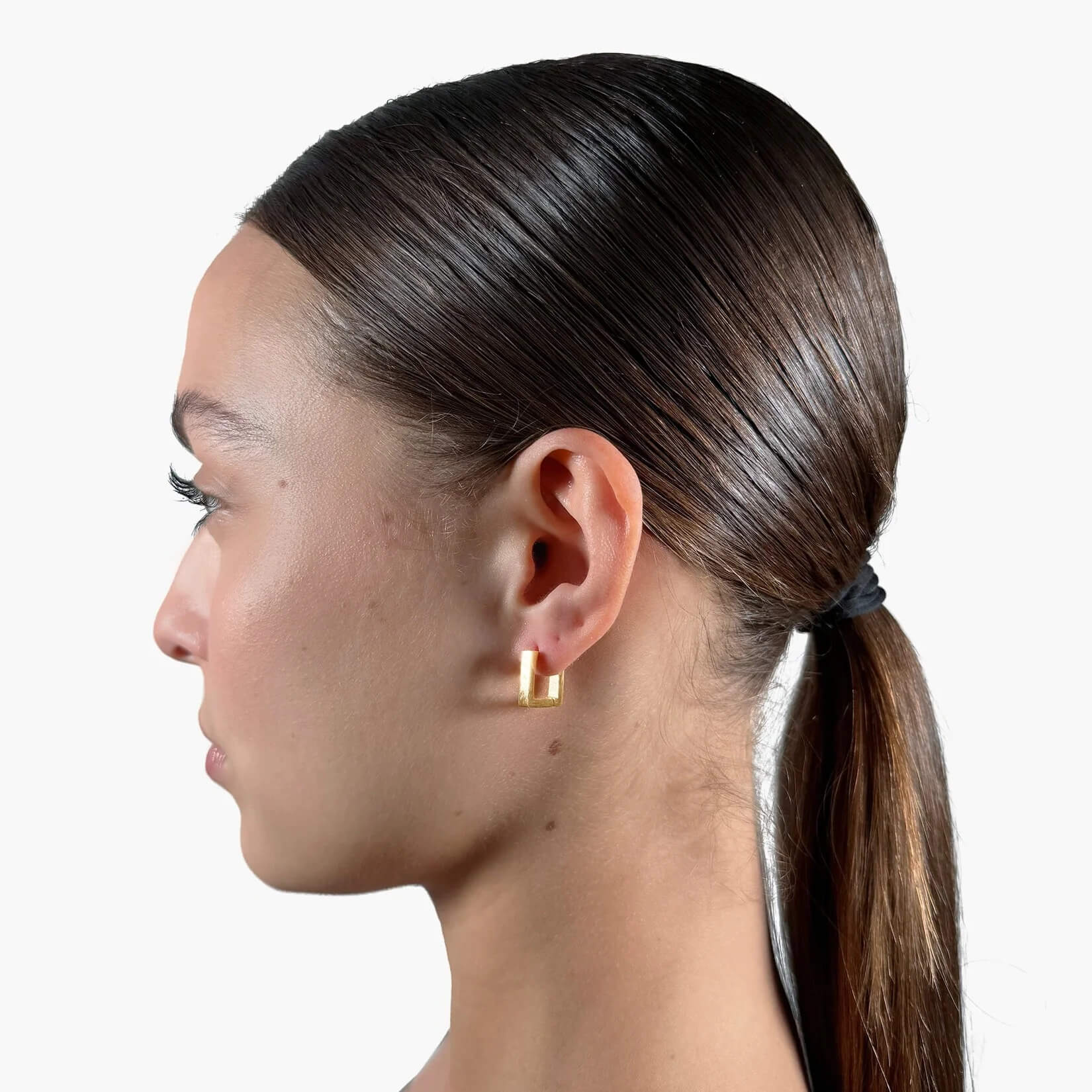 Model wearing Block Hoop Earrings gold