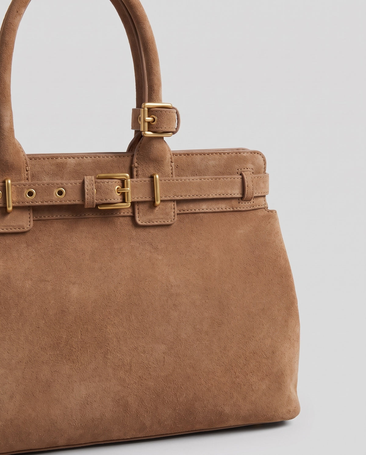 Gold buckle detail on the Spello top-handle bag in Camel