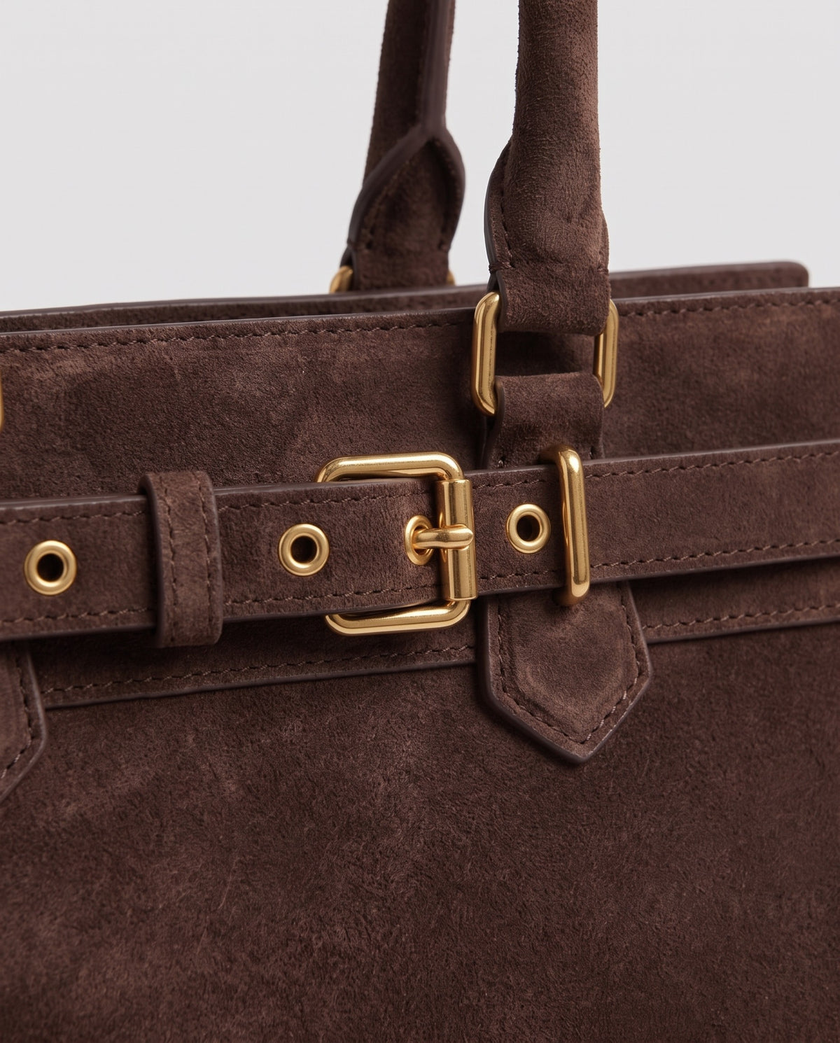 Gold buckle detail on the Spello top-handle bag in Chocolate