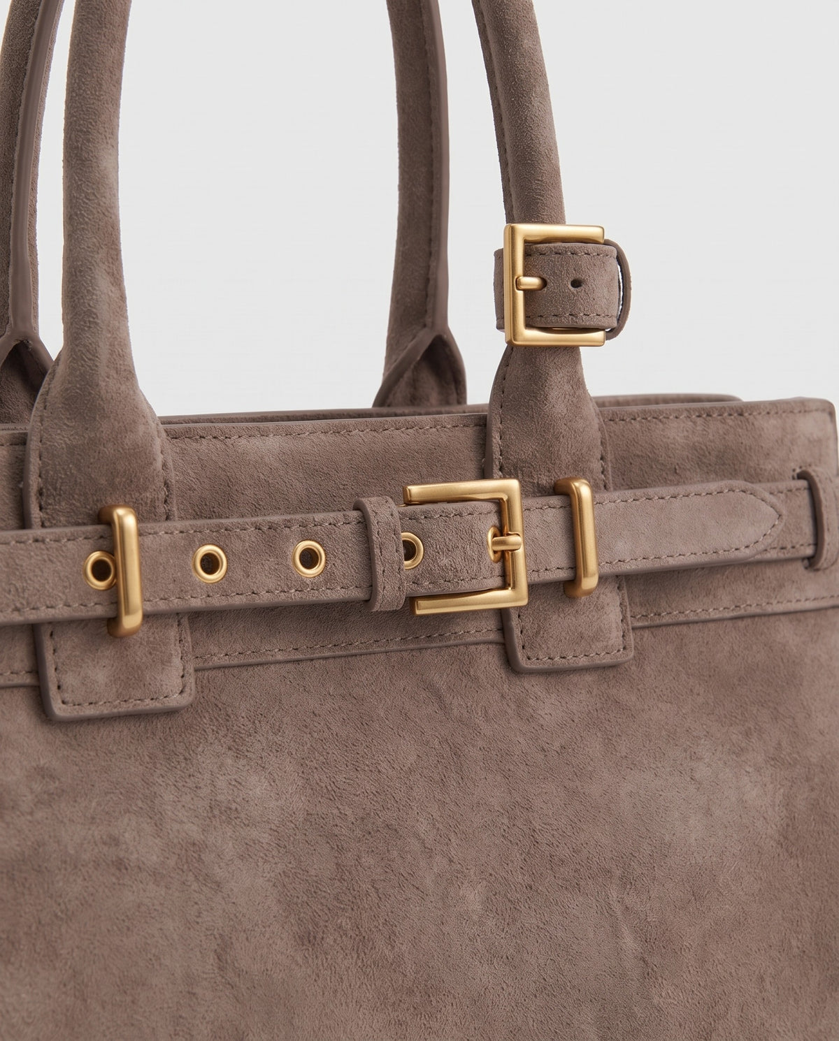 Gold buckle detail on the Spello top-handle bag in Taupe