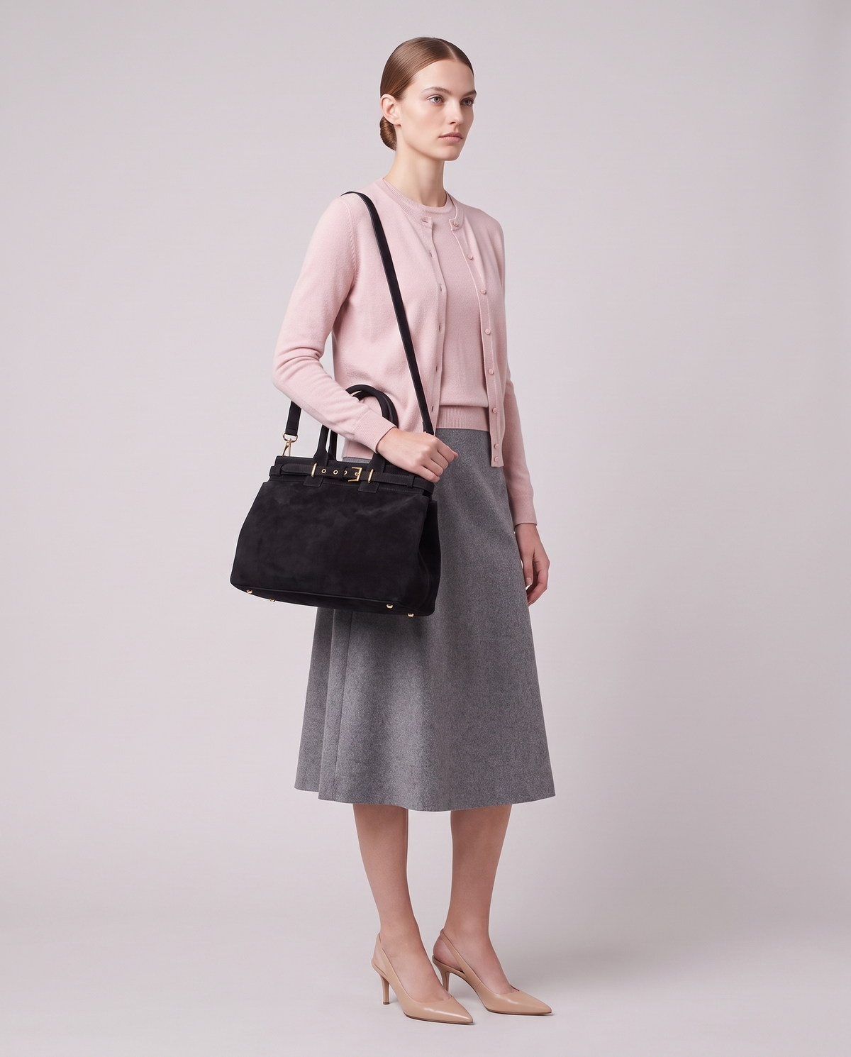 Model carrying the Spello top-handle bag in Black