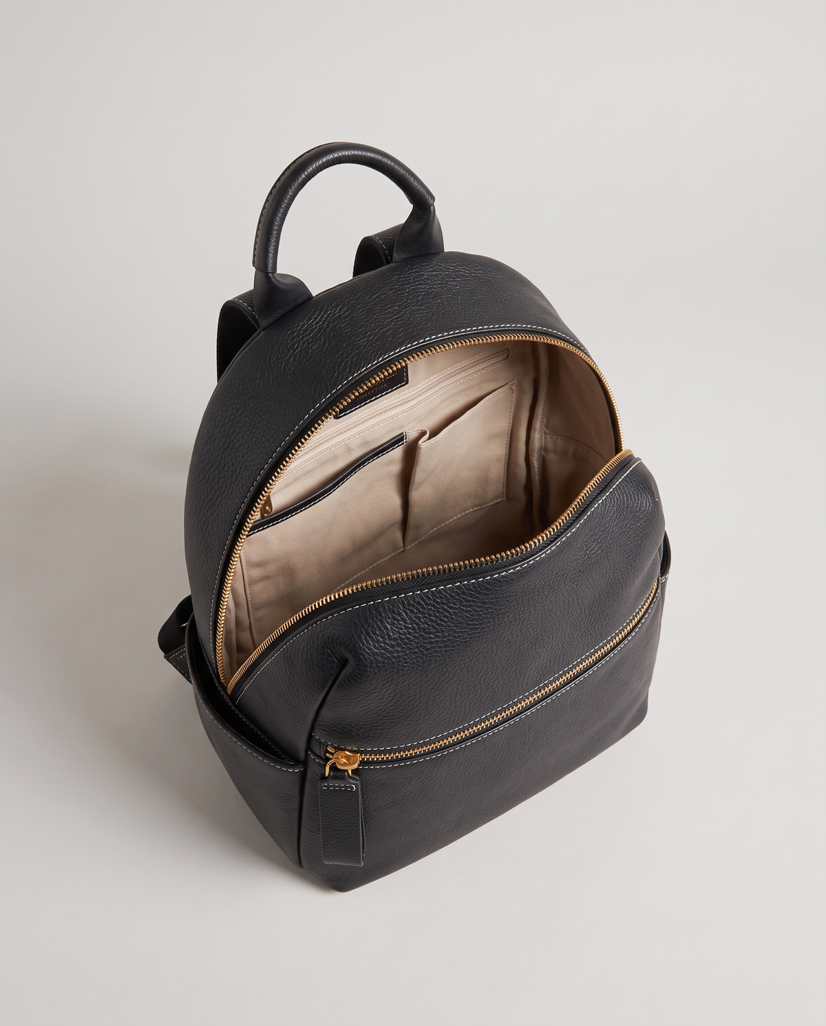 Tab pebbled leather backpack in Black – main compartment open, showing the lined interior