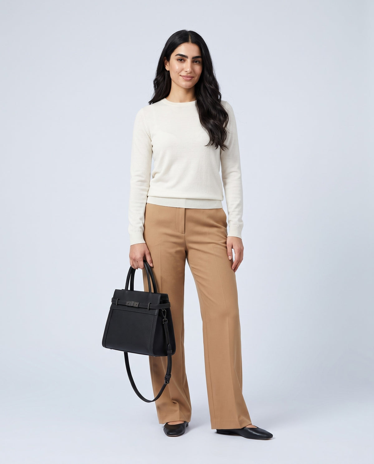 Model carrying the Taormina leather bag in Black – full length