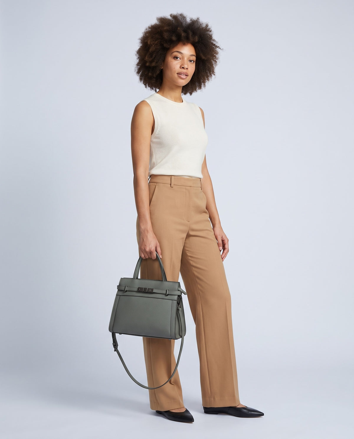 Model carrying the Taormina leather bag in Sage – full length