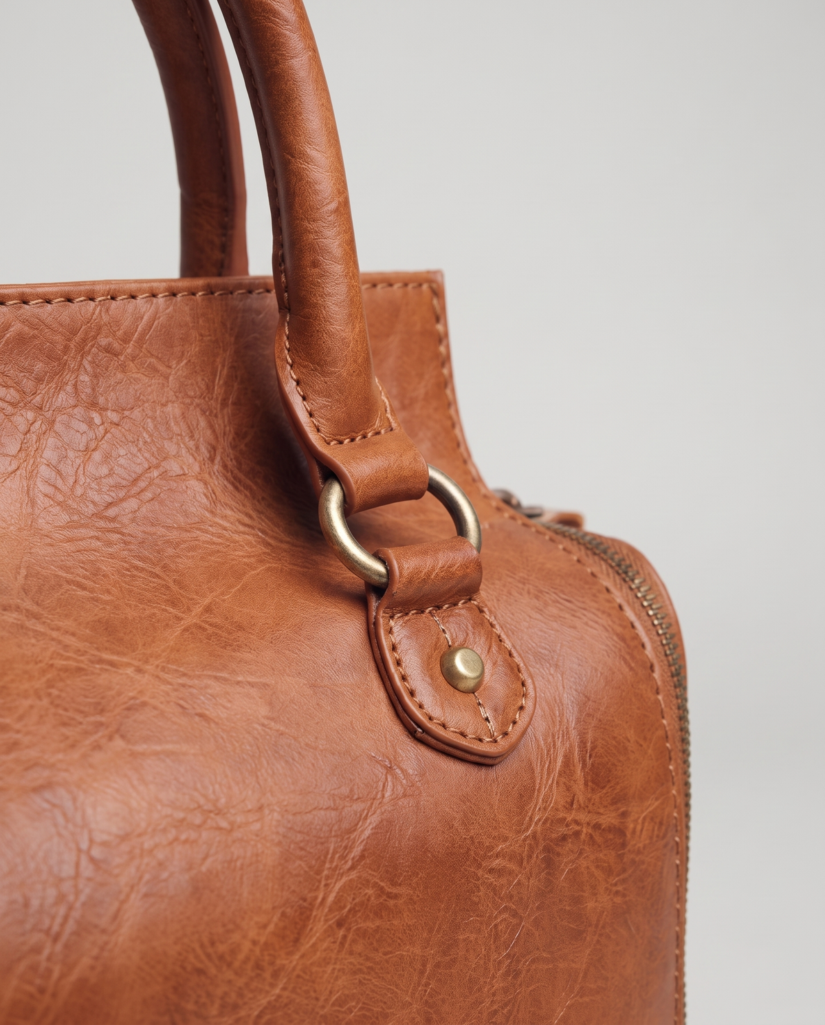 Terra leather satchel in Brown – close-up of the brass D-ring, rivet and handle