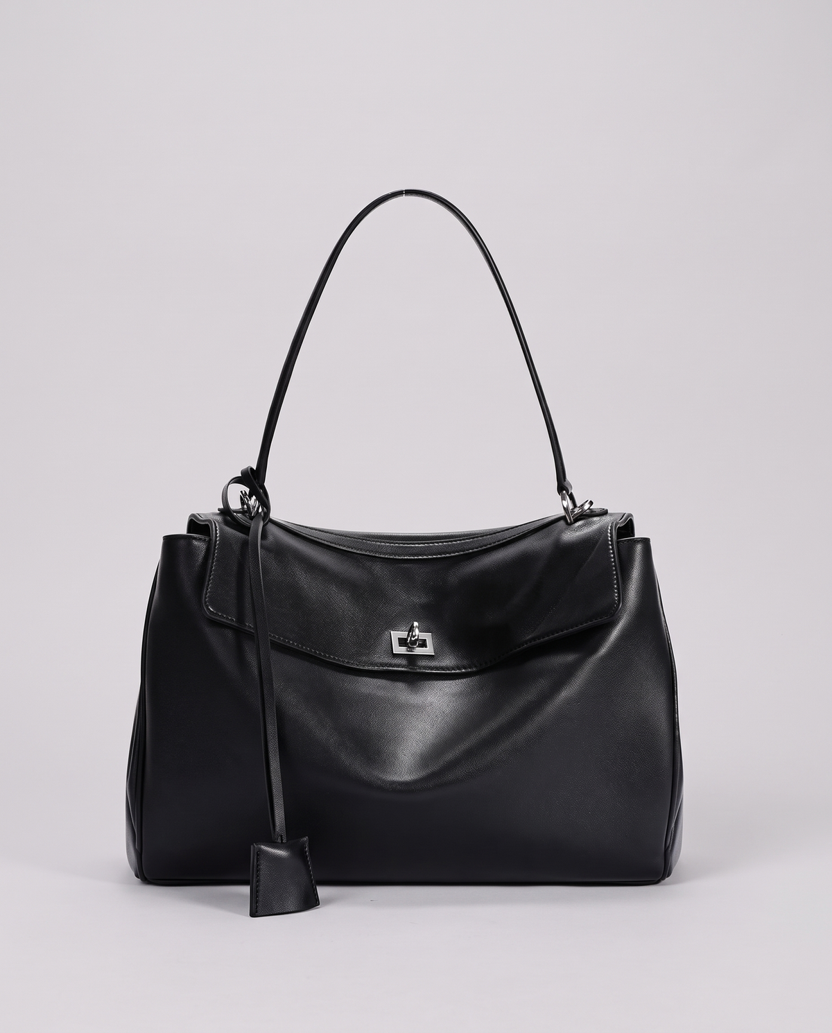 Hardware and handle detail on the Valentina Tinto Large bag in Onyx