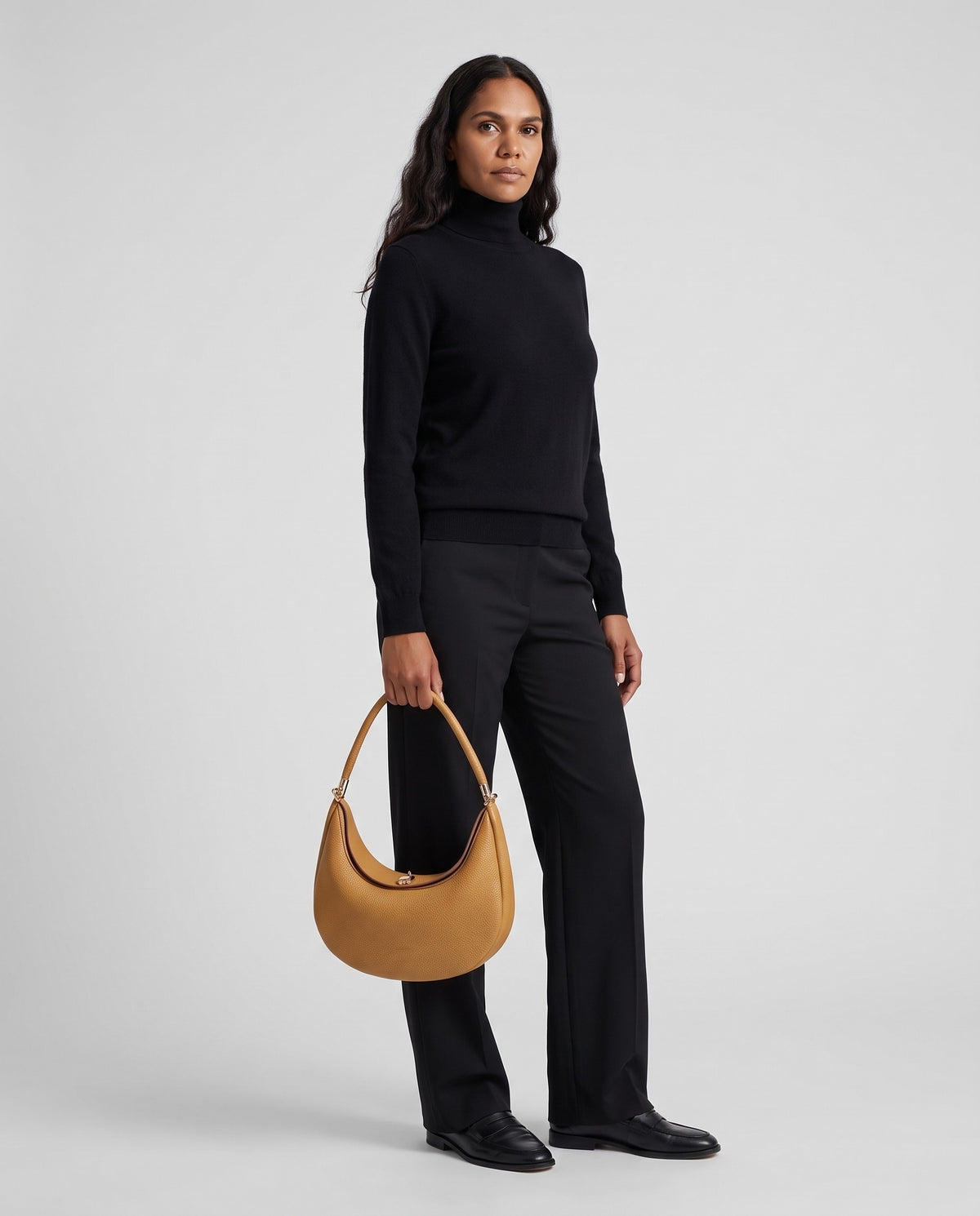 Model wearing the Todi crescent bag in Caramel – full-length view