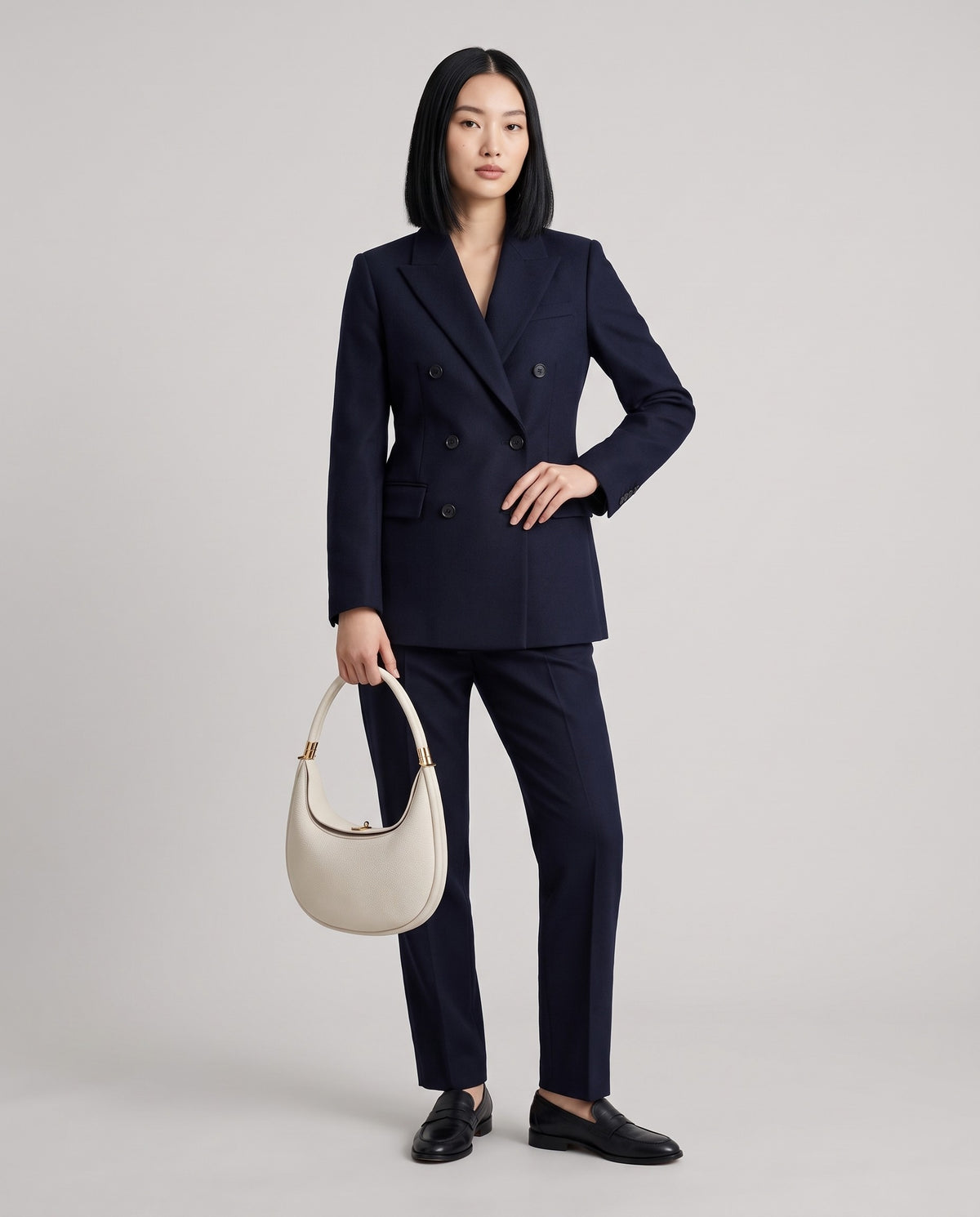 Model wearing the Todi crescent bag in Ivory – full-length view