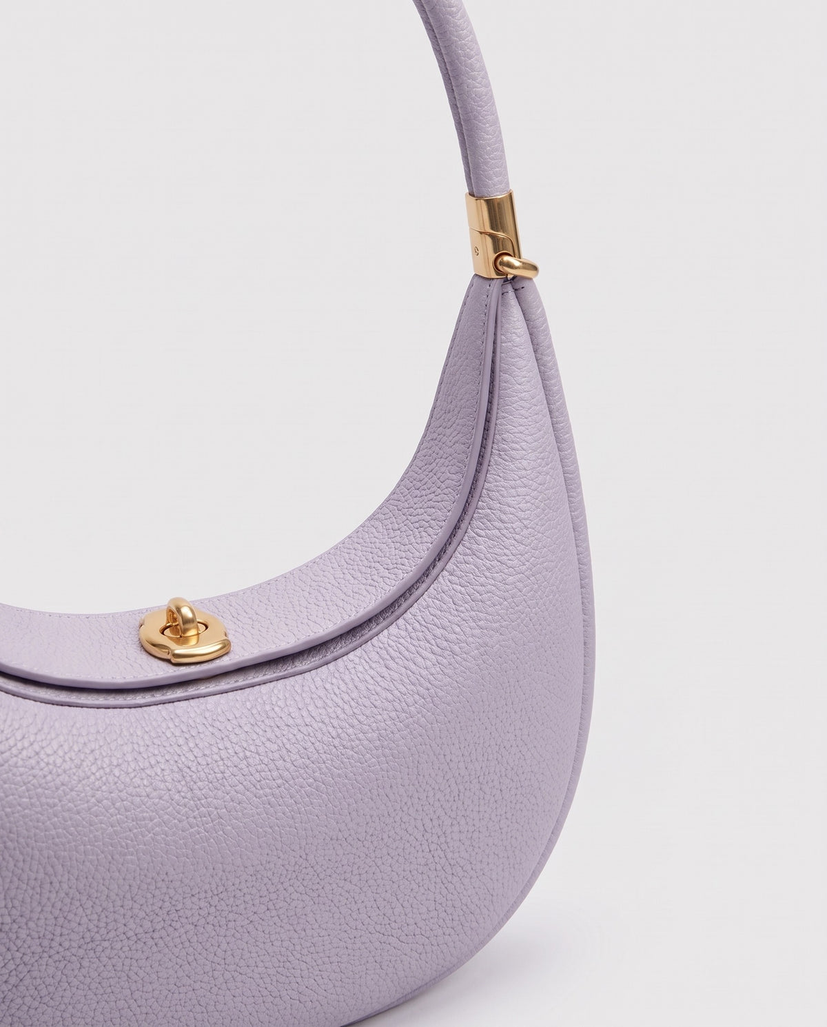 Gold clasp and handle collar detail on the Todi crescent bag in Lavender
