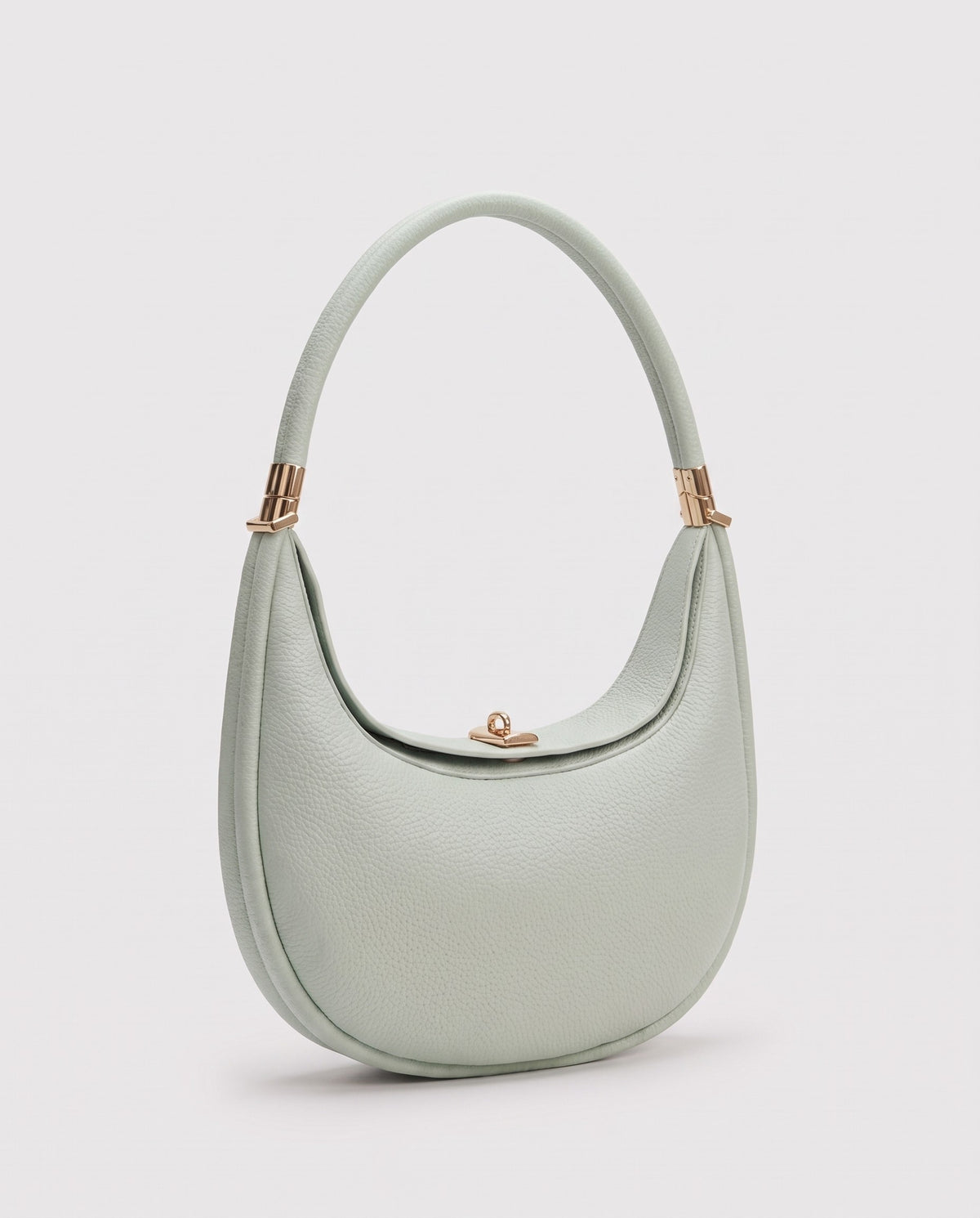 Todi pebbled leather crescent bag in Mint – three-quarter view