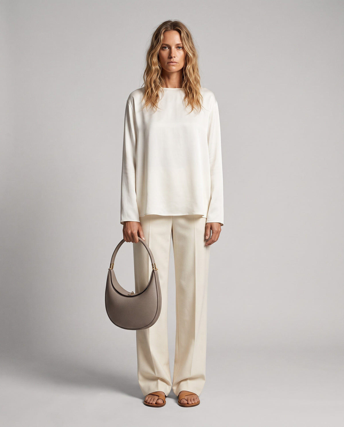 Model wearing the Todi crescent bag in Taupe – full-length view