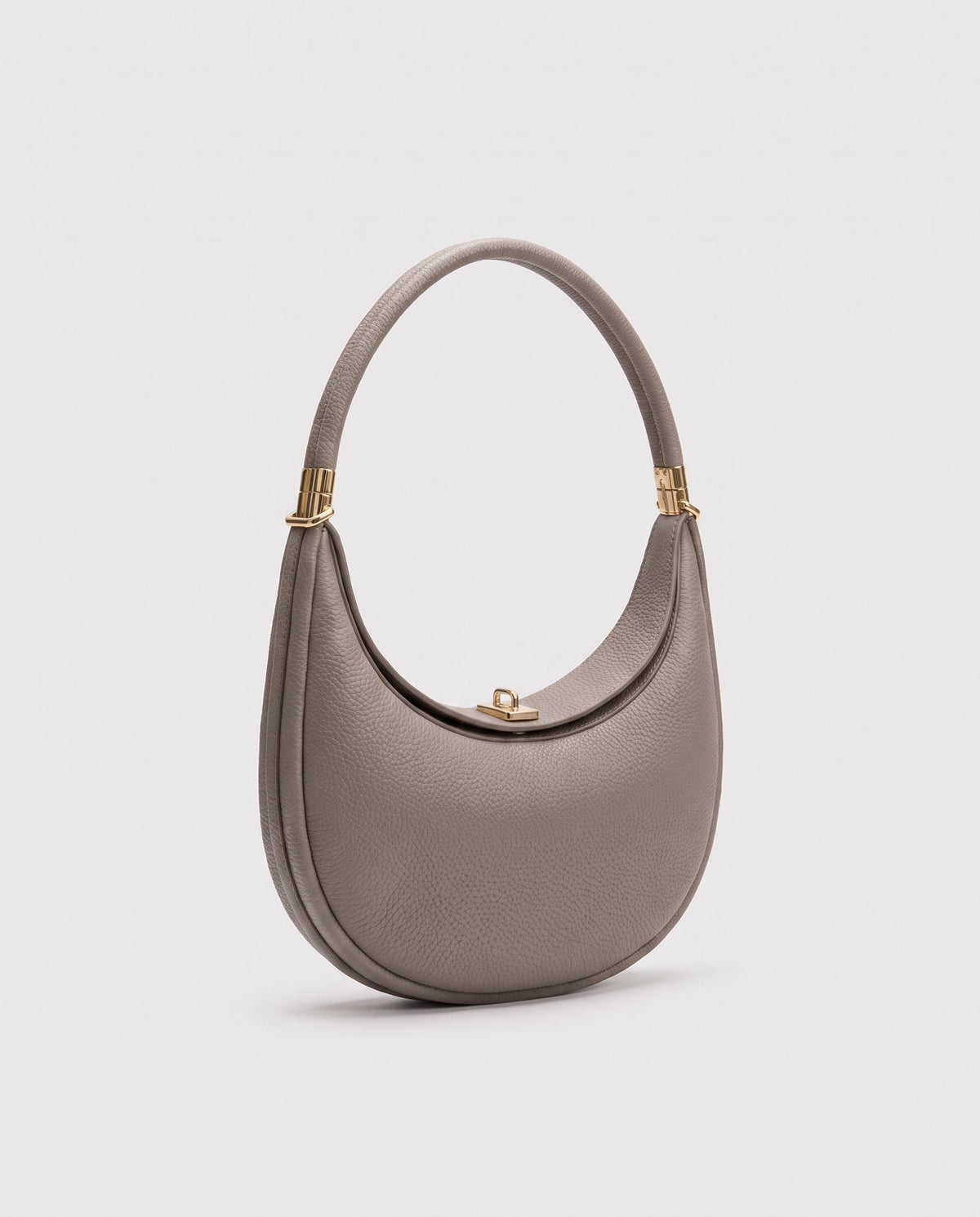 Todi pebbled leather crescent bag in Taupe – three-quarter view