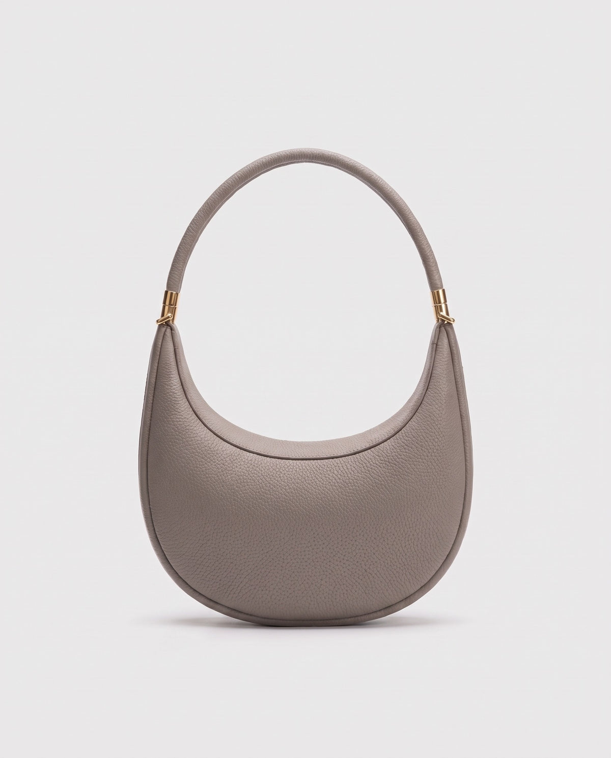 Todi pebbled leather crescent bag in Taupe – back view