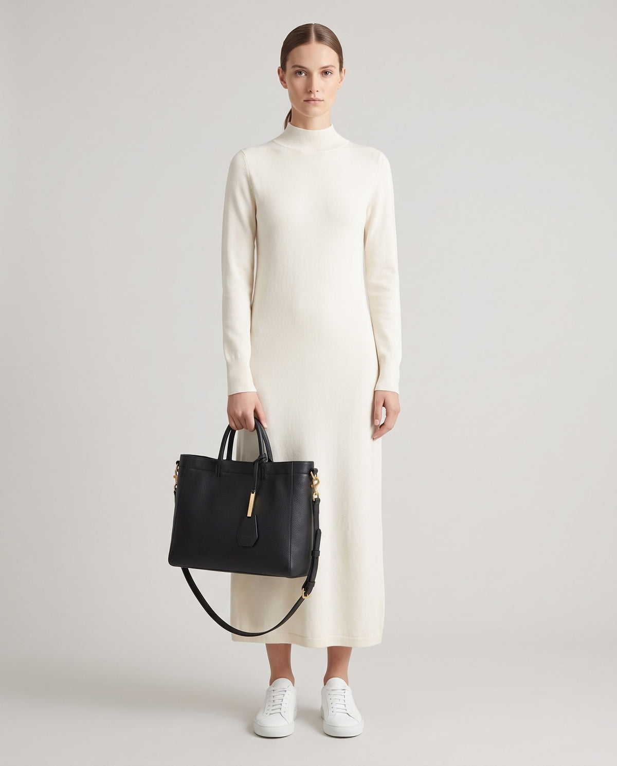 Torre Large leather tote in Black – model holding it, full length
