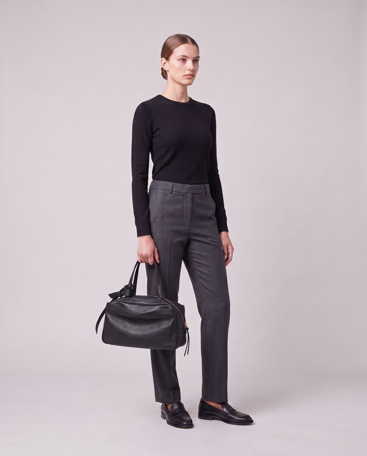 Model holding the Valentina Treviso Large bag in Black, full length
