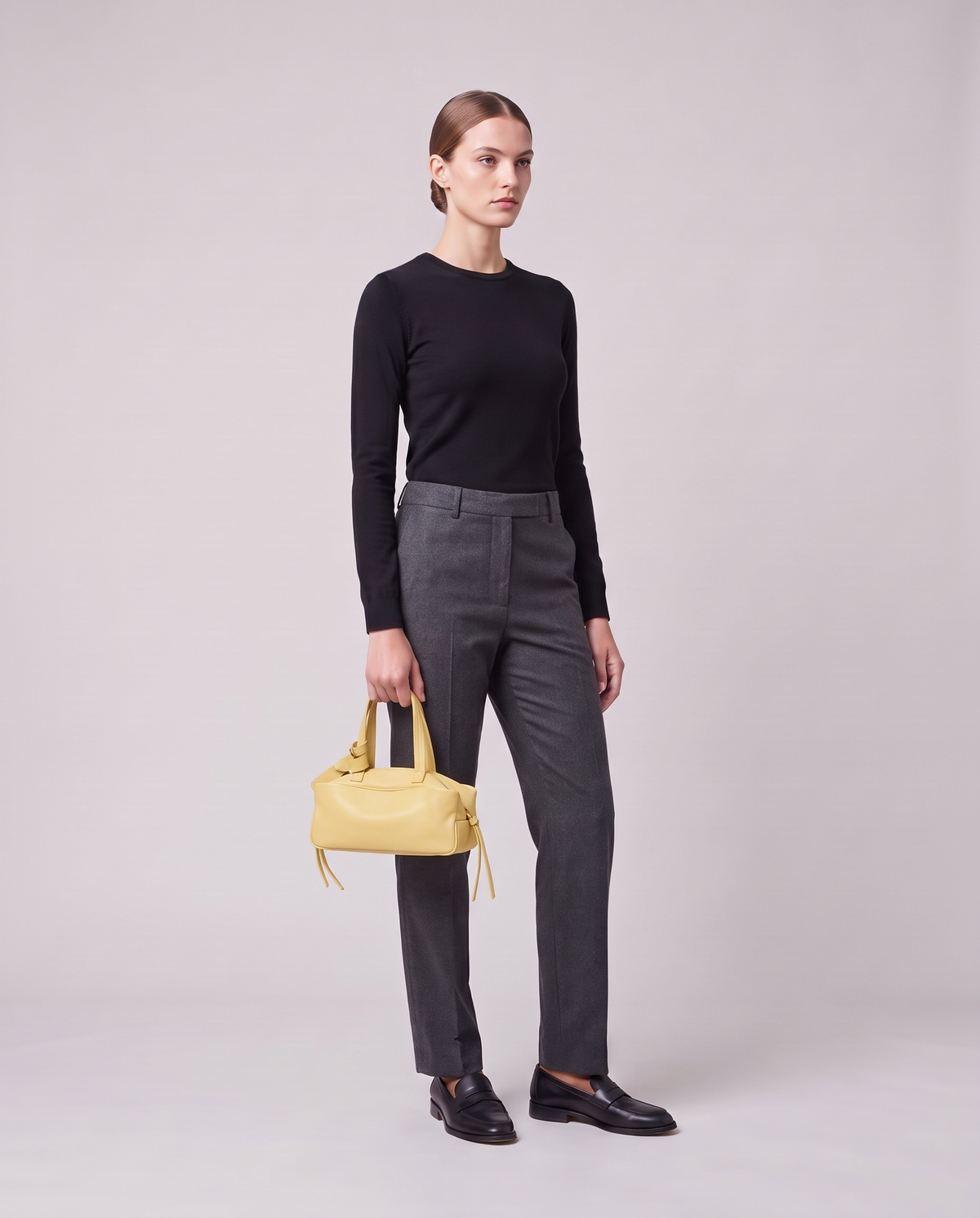 Model holding the Valentina Treviso Small bag in Butter, full length
