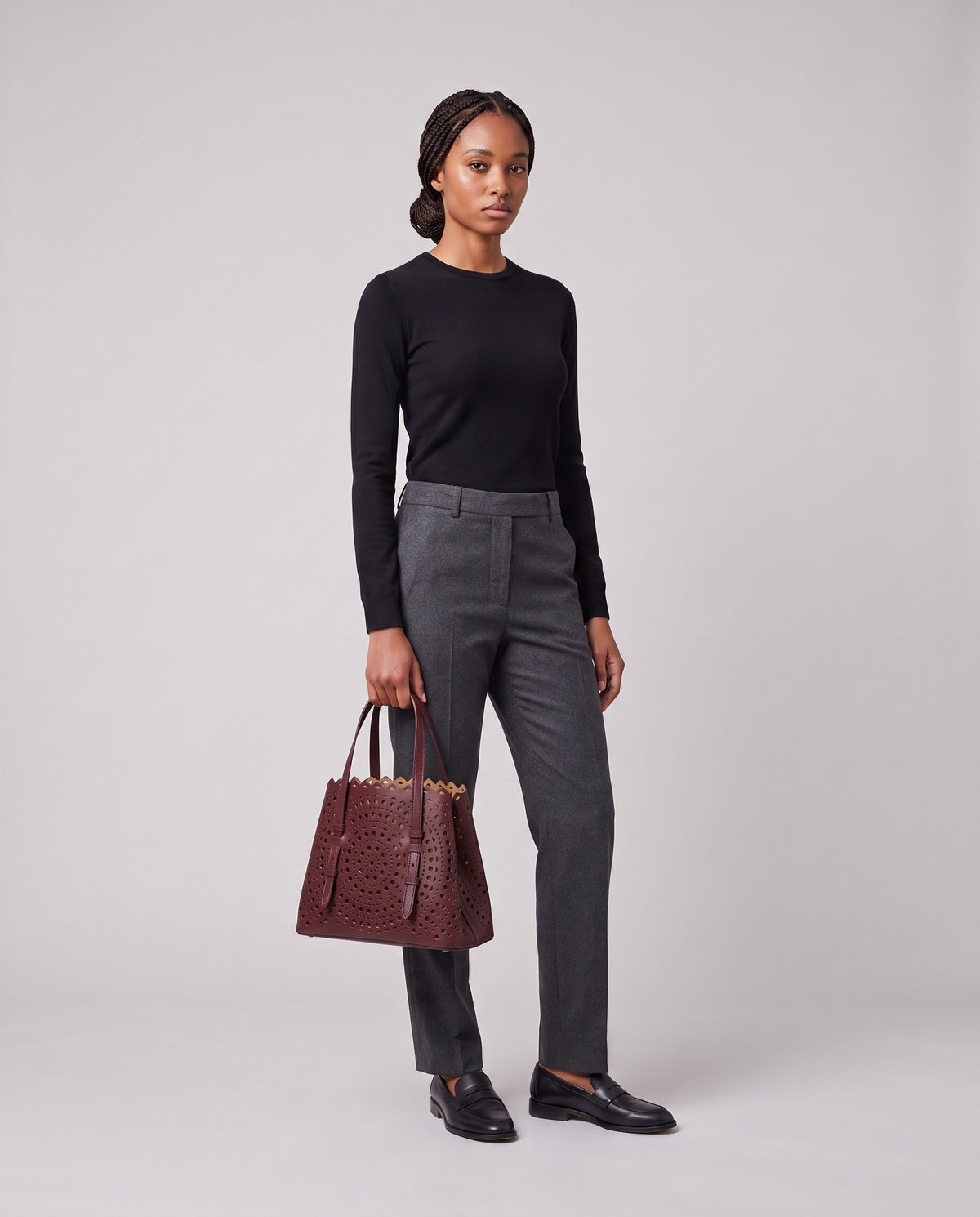 Model holding the Valentina Urbino Medium bag in Burgundy, full length