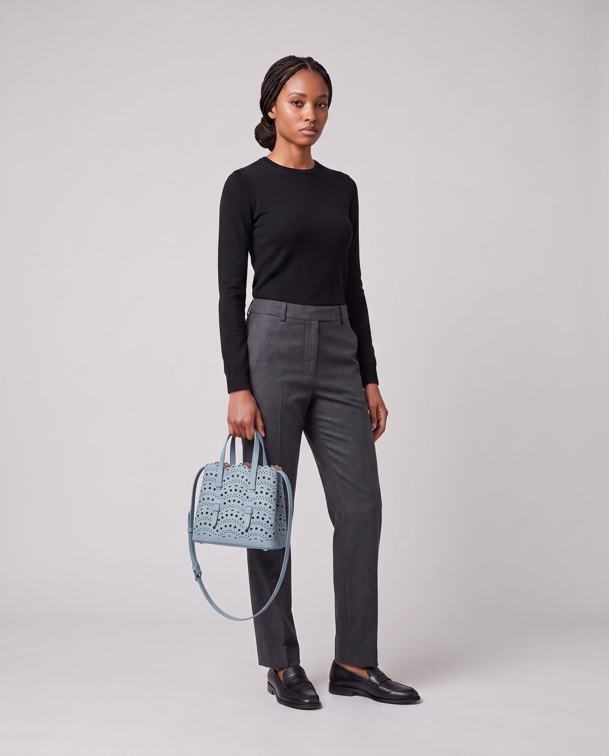 Model holding the Valentina Urbino Medium bag in Sky, full length