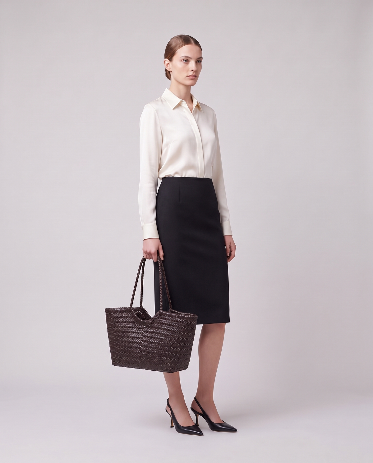 Model holding the Valentina Bosa bag in Chocolate, full length