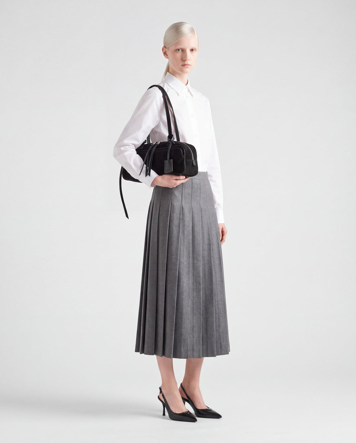 Model wearing the Valentina Linea suede shoulder bag in Black on the shoulder