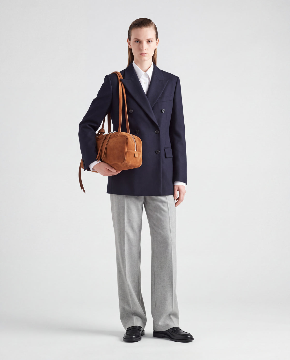 Model carrying the Valentina Linea suede shoulder bag in Brown on the arm
