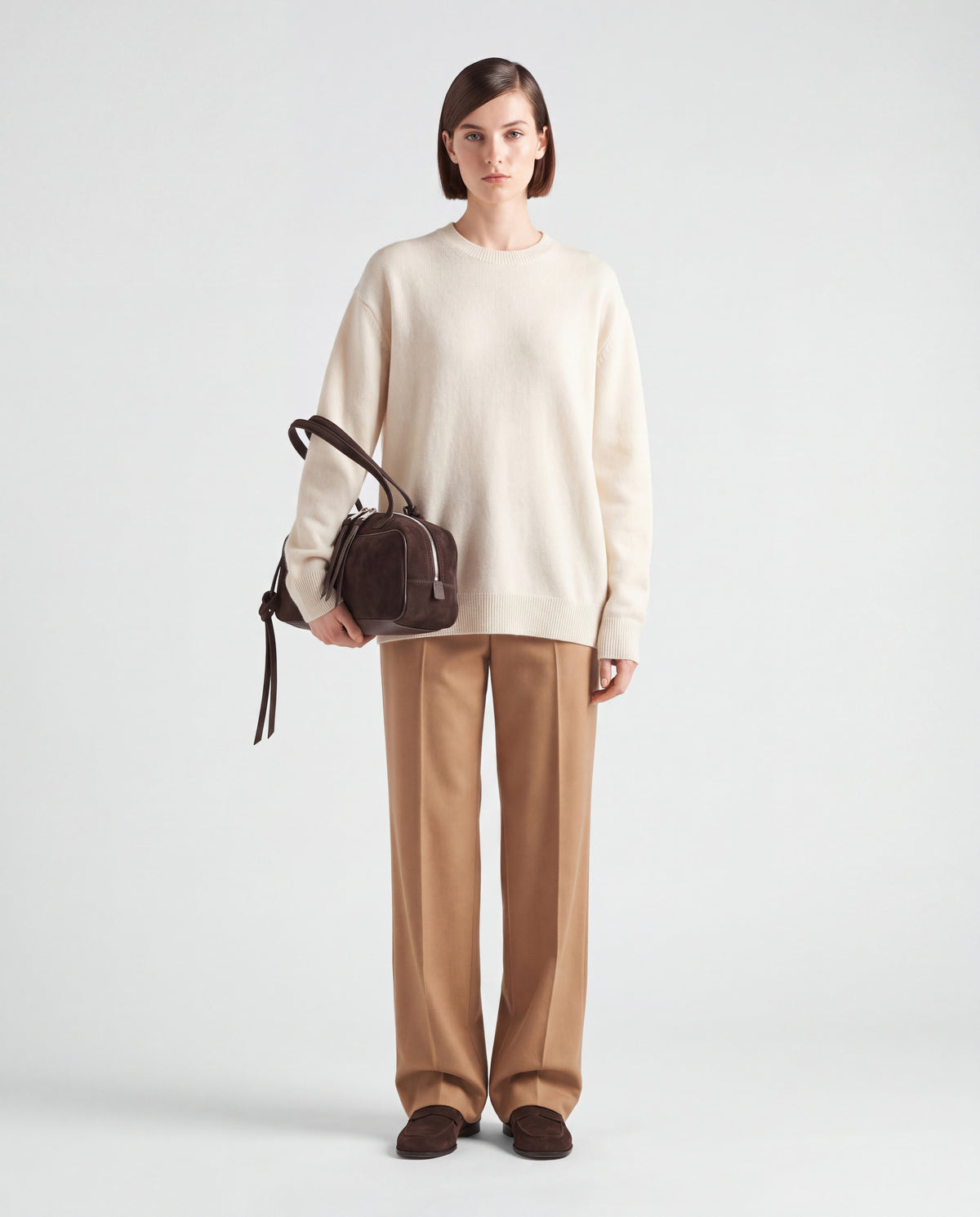 Model carrying the Valentina Linea suede shoulder bag in Chocolate on the arm
