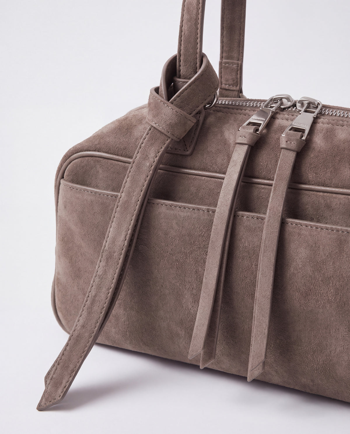 Detail of the knotted strap, double silver zips and suede pulls on the Valentina Linea bag in Taupe