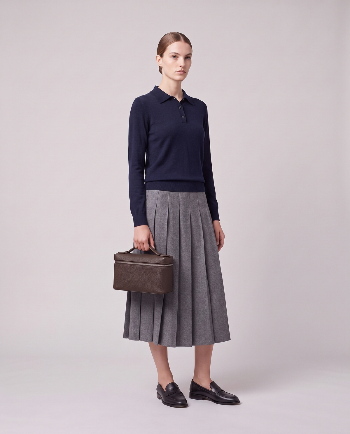 Model carrying the Valentina Orvieto Small top-handle bag in Chocolate leather