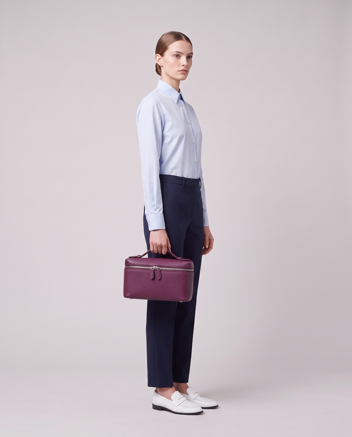 Model carrying the Valentina Orvieto Small top-handle bag in Purple leather