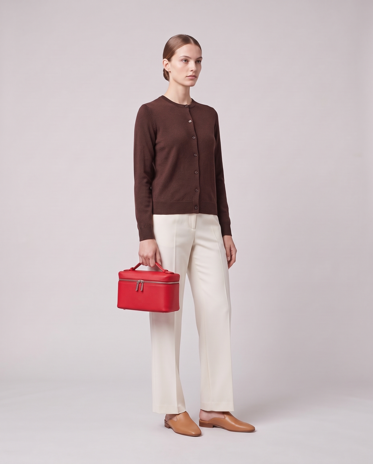 Model carrying the Valentina Orvieto Small top-handle bag in Red leather