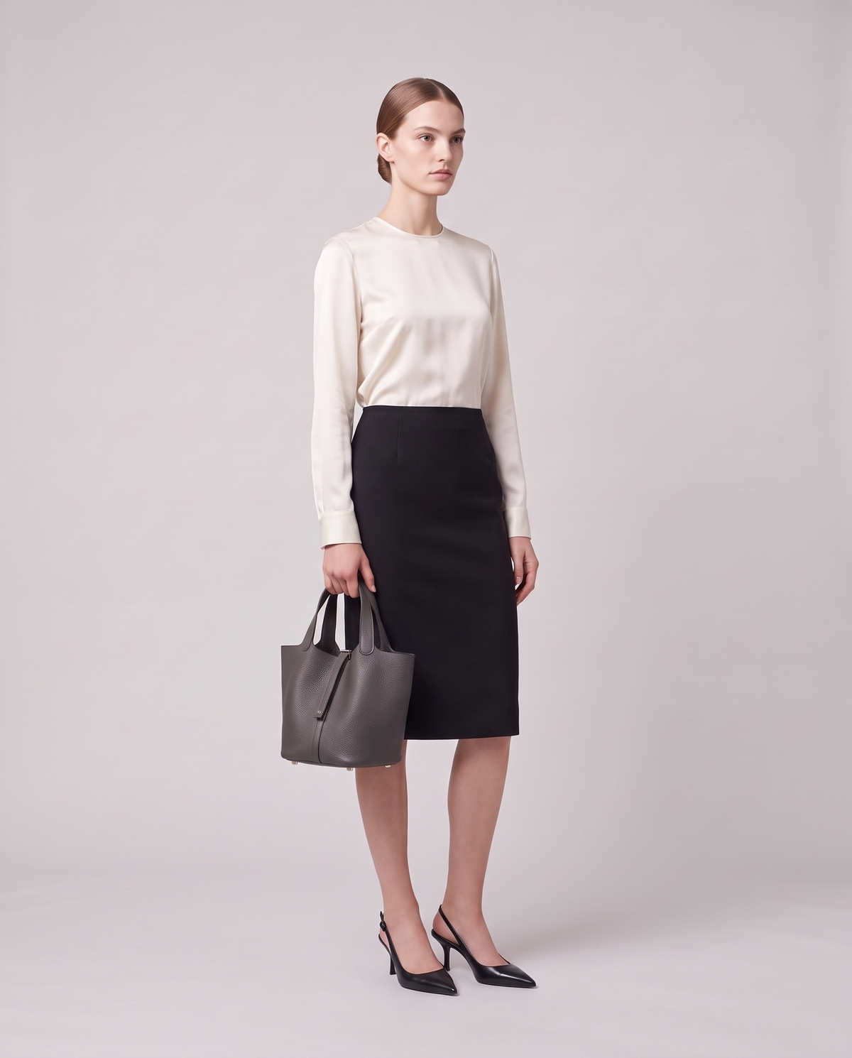 Model holding the Valentina Ostuni Small bag in Grey, full length