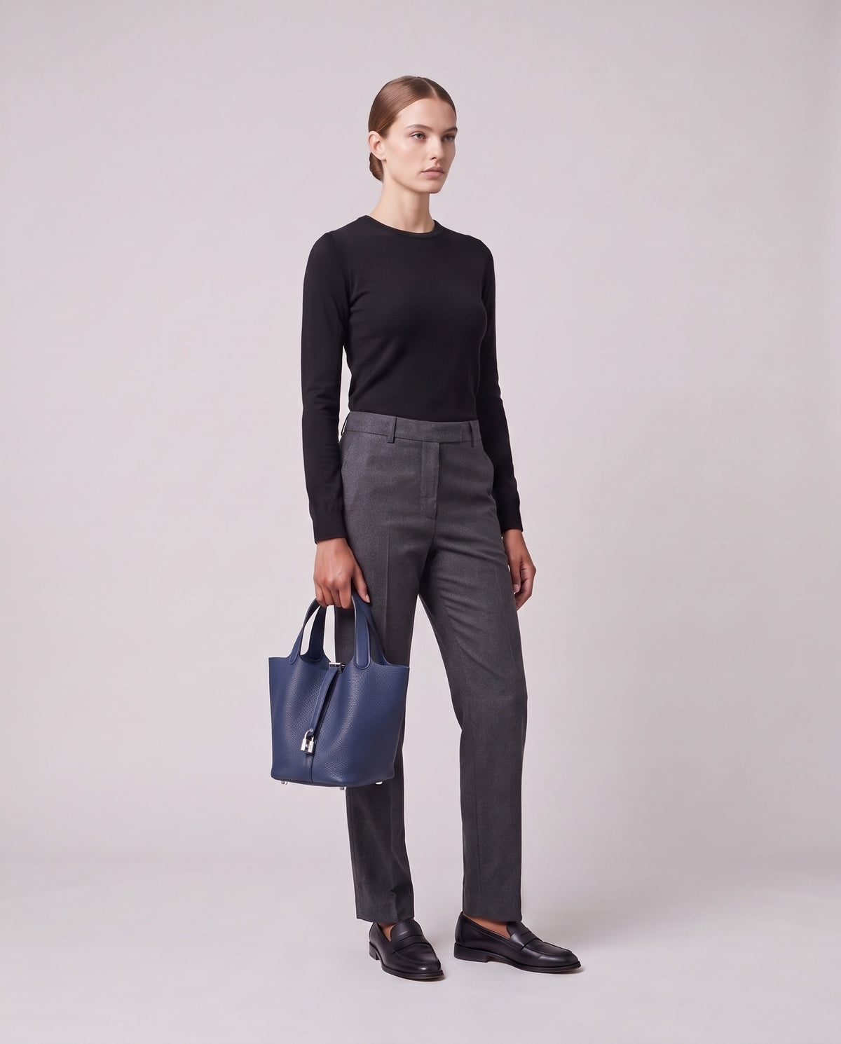 Model holding the Valentina Ostuni Small bag in Navy, full length