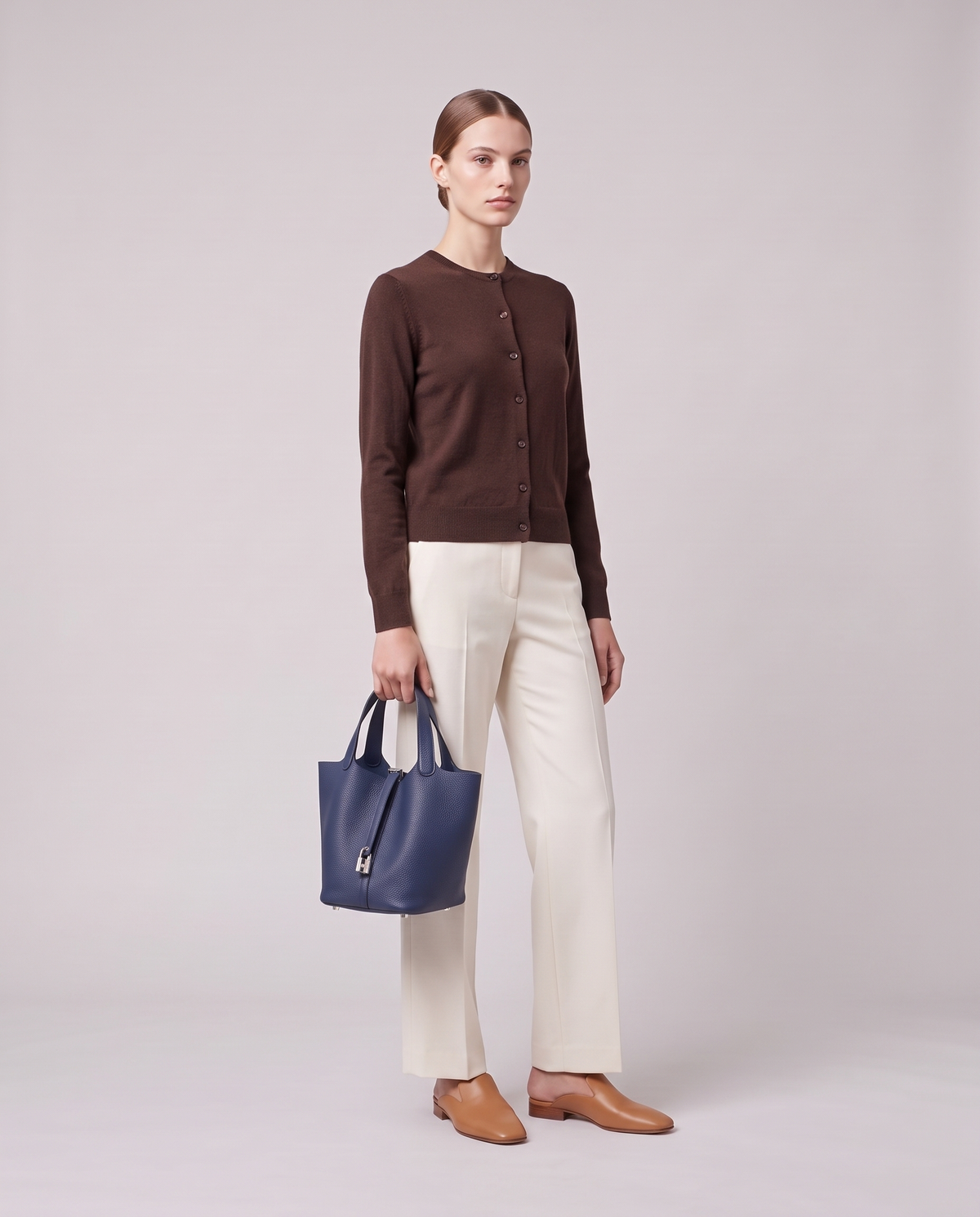 Model holding the Valentina Ostuni Small bag in Navy, full length