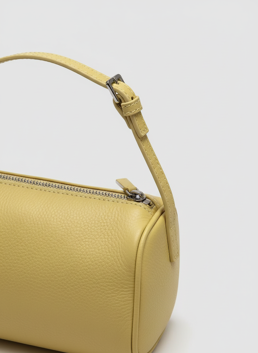 Close-up detail of the pale yellow leather and silver zip on the Valentina Roma barrel bag