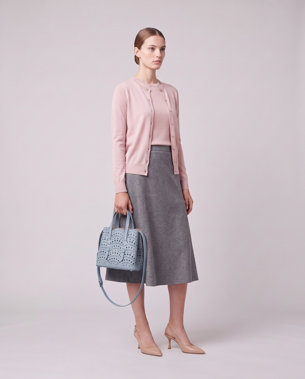 Model holding the Valentina Urbino Large bag in Sky, full length