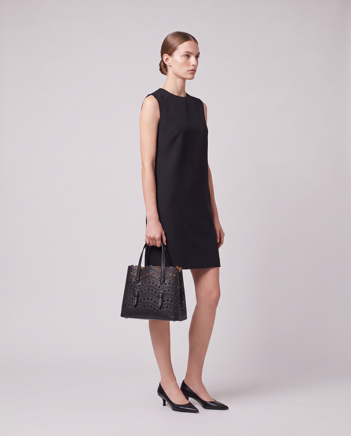 Model carrying the Valentina Urbino Medium bag in Black
